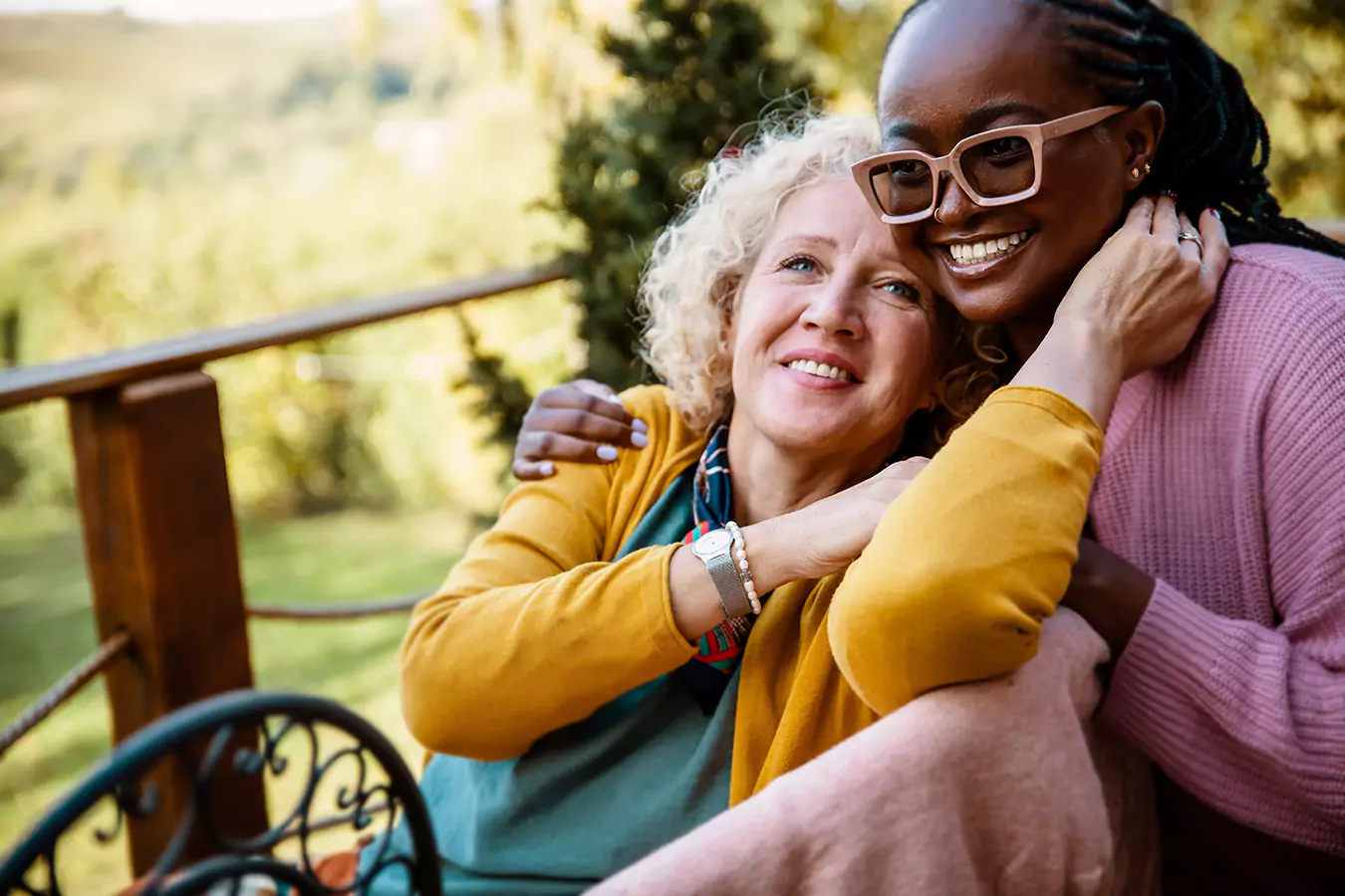 Two women smiling while holding each other